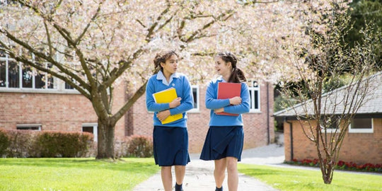 Two girls are talking together