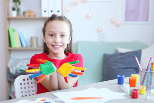 cute little girl draws paints at home